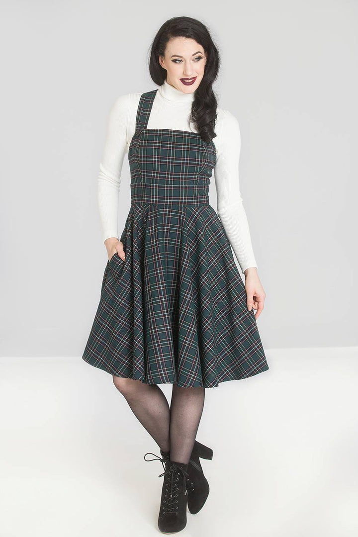 Woman wearing a tartan pinafore dress